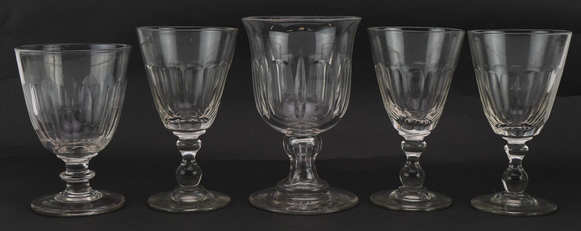 Five 19th century glasses with facetted bowls, the largest 16cm high