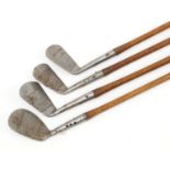 Four antique Ted Paris and Mashie Miblick wooden shafted golf clubs, each approximately 100cm in