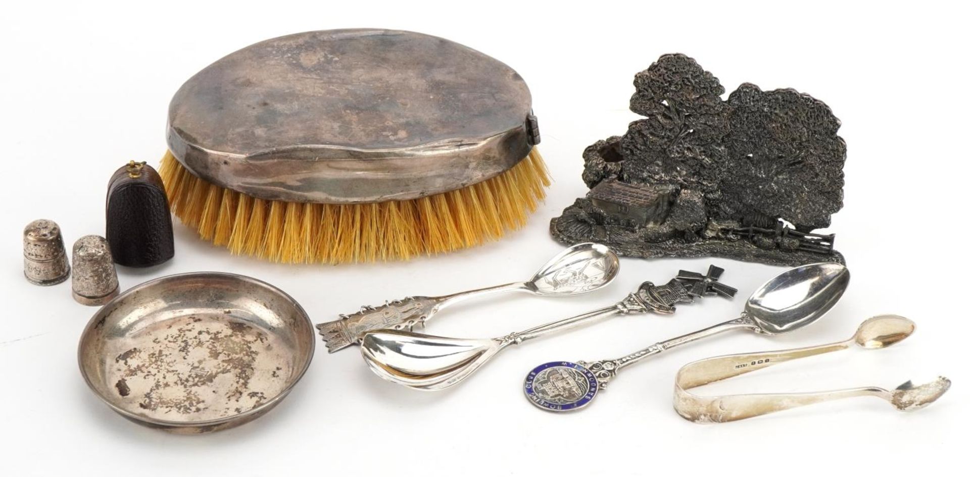 Silver and white metal objects including a silver backed clothes brush, thimbles, teaspoons and a