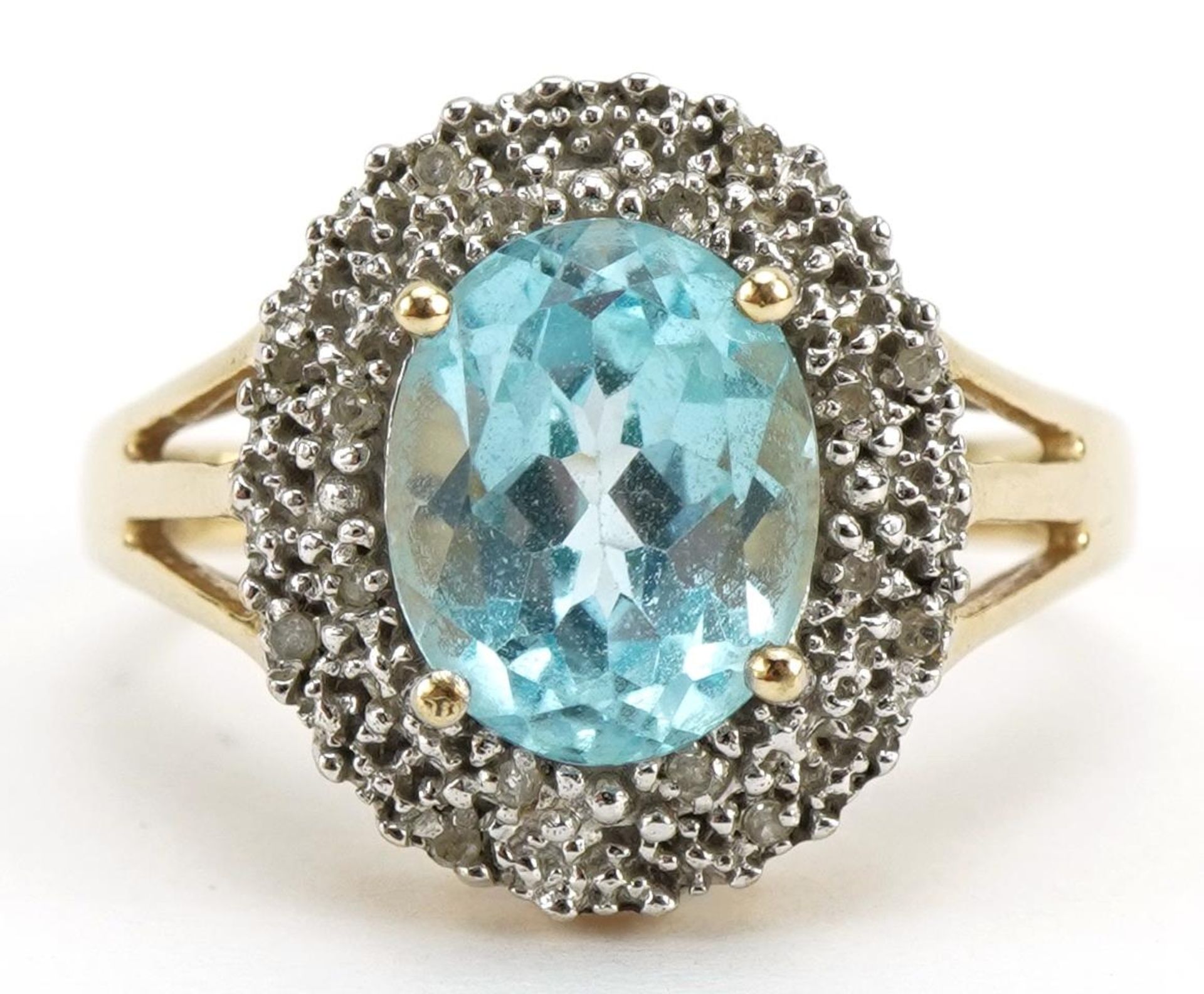 9ct gold aquamarine and diamond cluster ring with split shoulders, the aquamarine approximately 10.