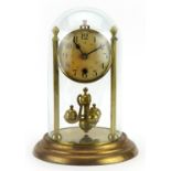Brass anniversary clock under glass dome. 28cm high