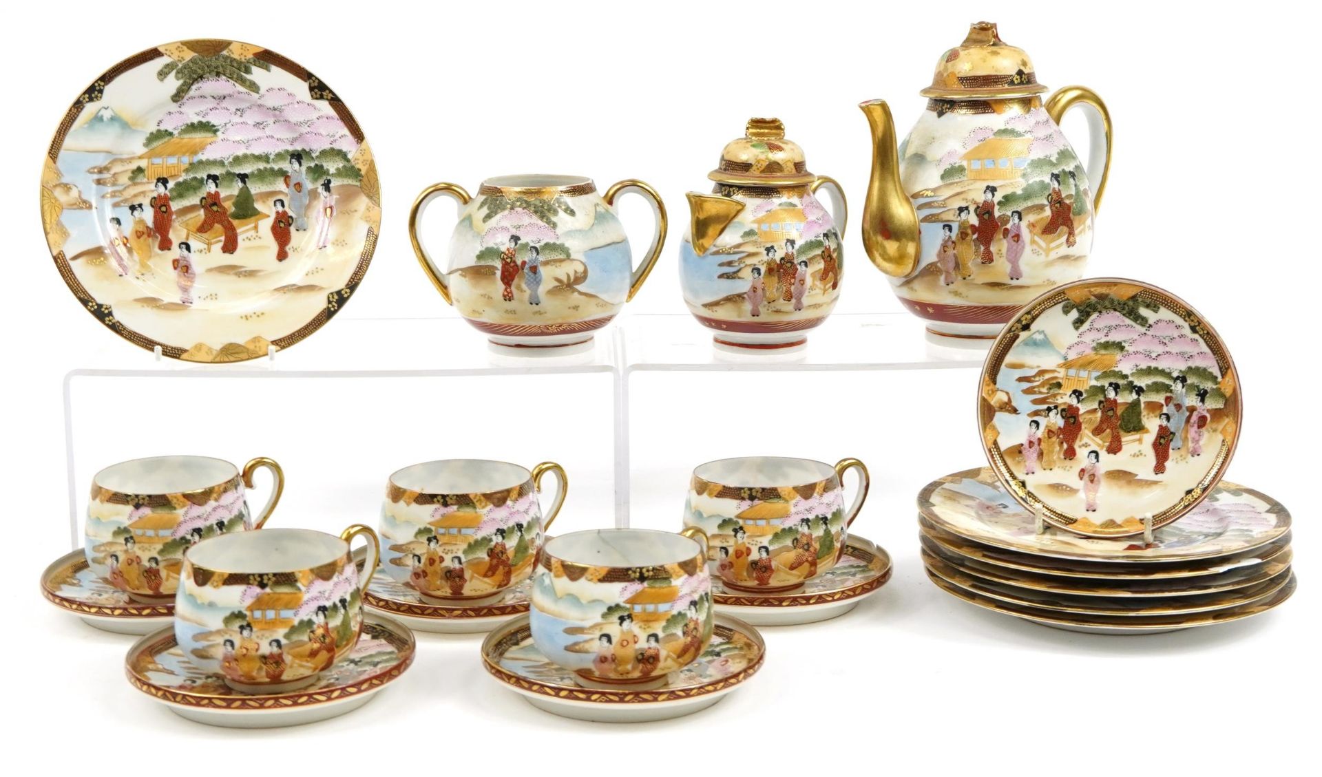 Japanese porcelain tea service hand painted with figures including a teapot and trios, the largest