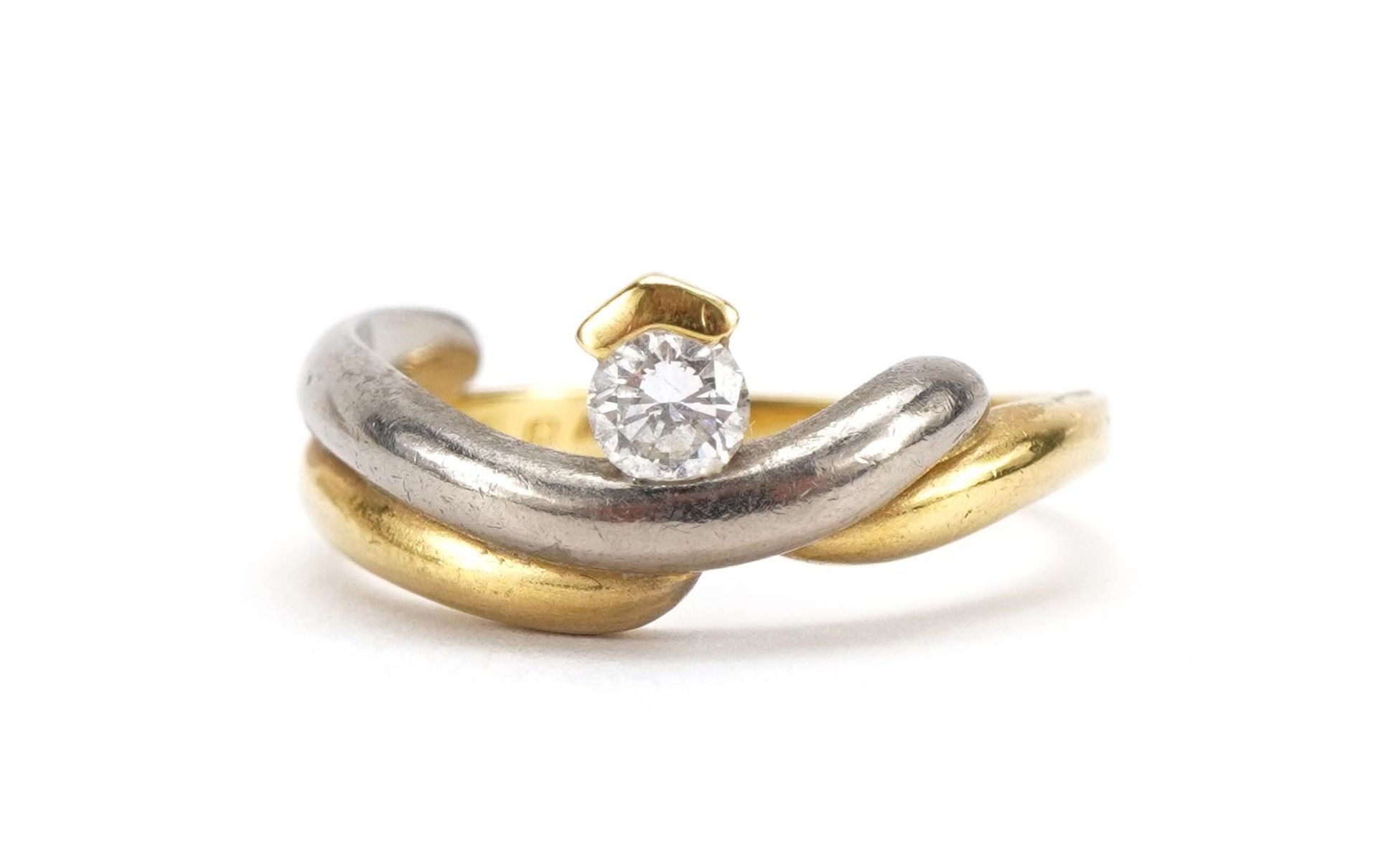 18ct two tone gold crossover ring set with a diamond, the diamond approximately 0.19 carat, size