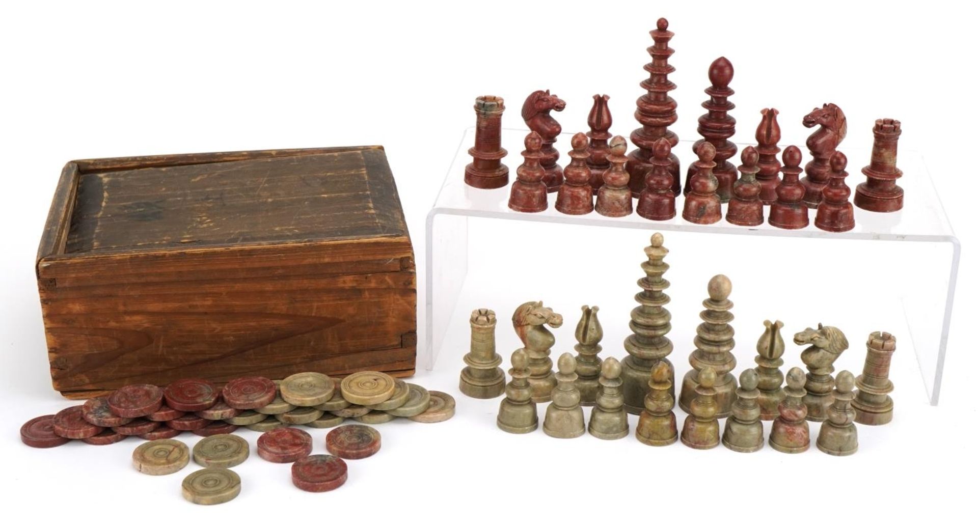 Chinese carved soapstone chess set and draughts pieces housed in a pine box, the largest pieces 10.