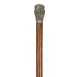 Wooden walking stick with Indian unmarked silver handle embossed with deities, 88cm in length