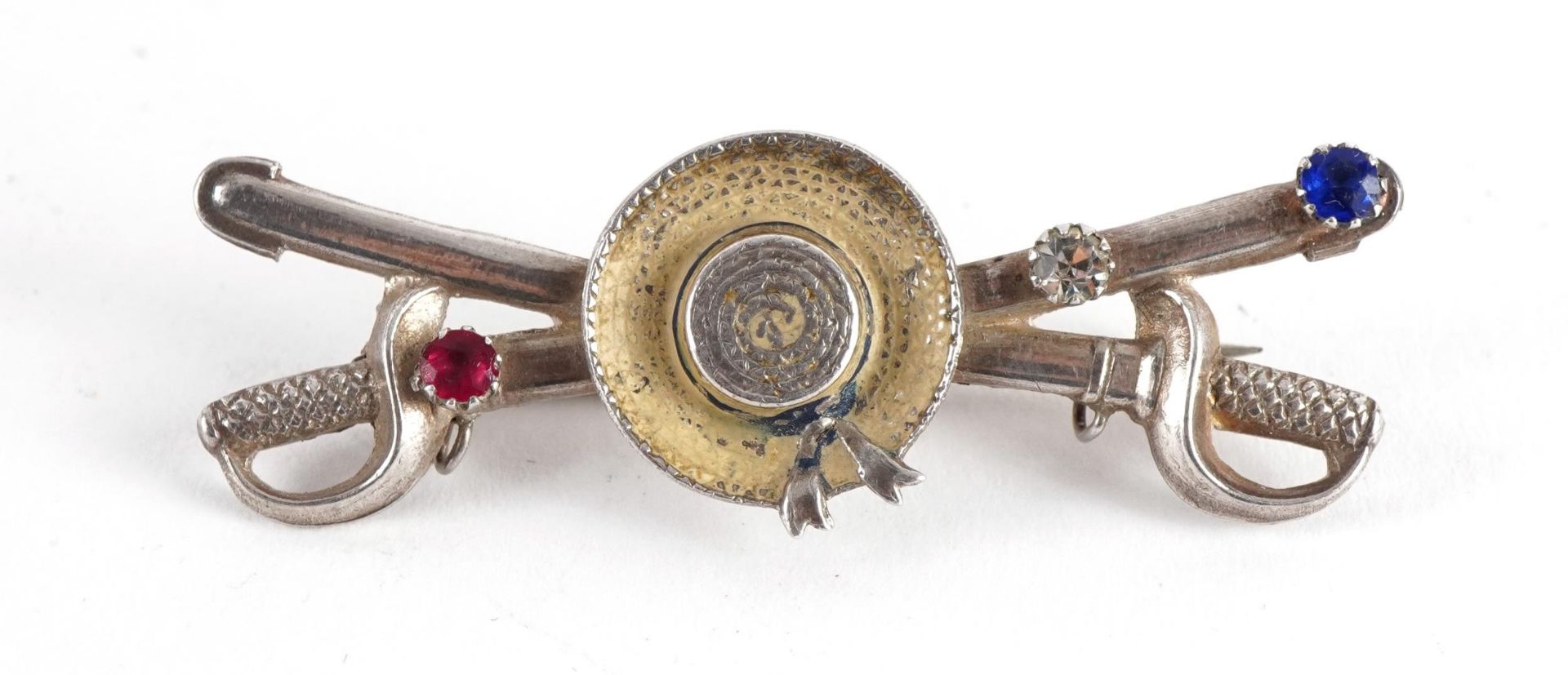 Silver hat and sword brooch set with red and blue stones, F R & Co, Birmingham 1914, registered