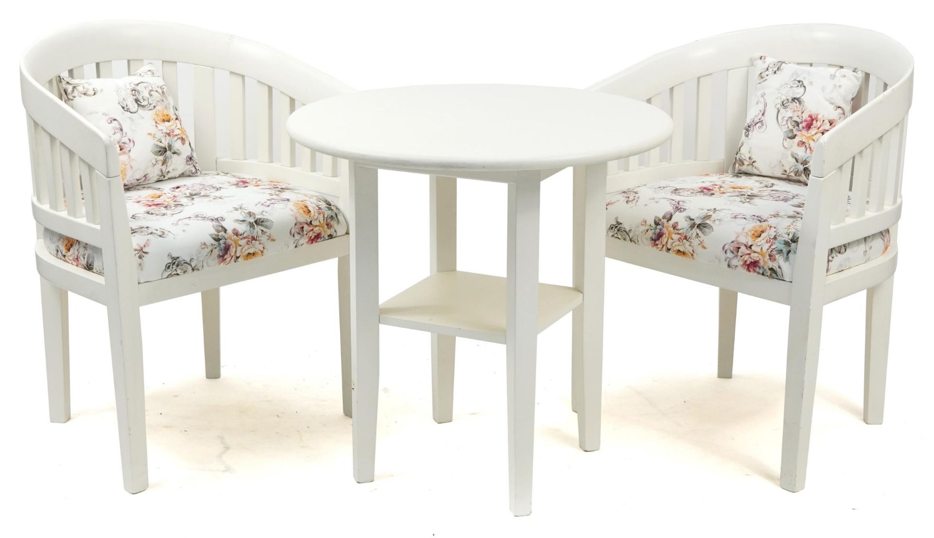 Circular white painted table and two chairs, the table 69cm high x 68cm in diameter