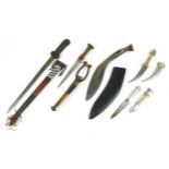 Five Middle Eastern knives and daggers with sheaths including one with crocodile skin sheath, one