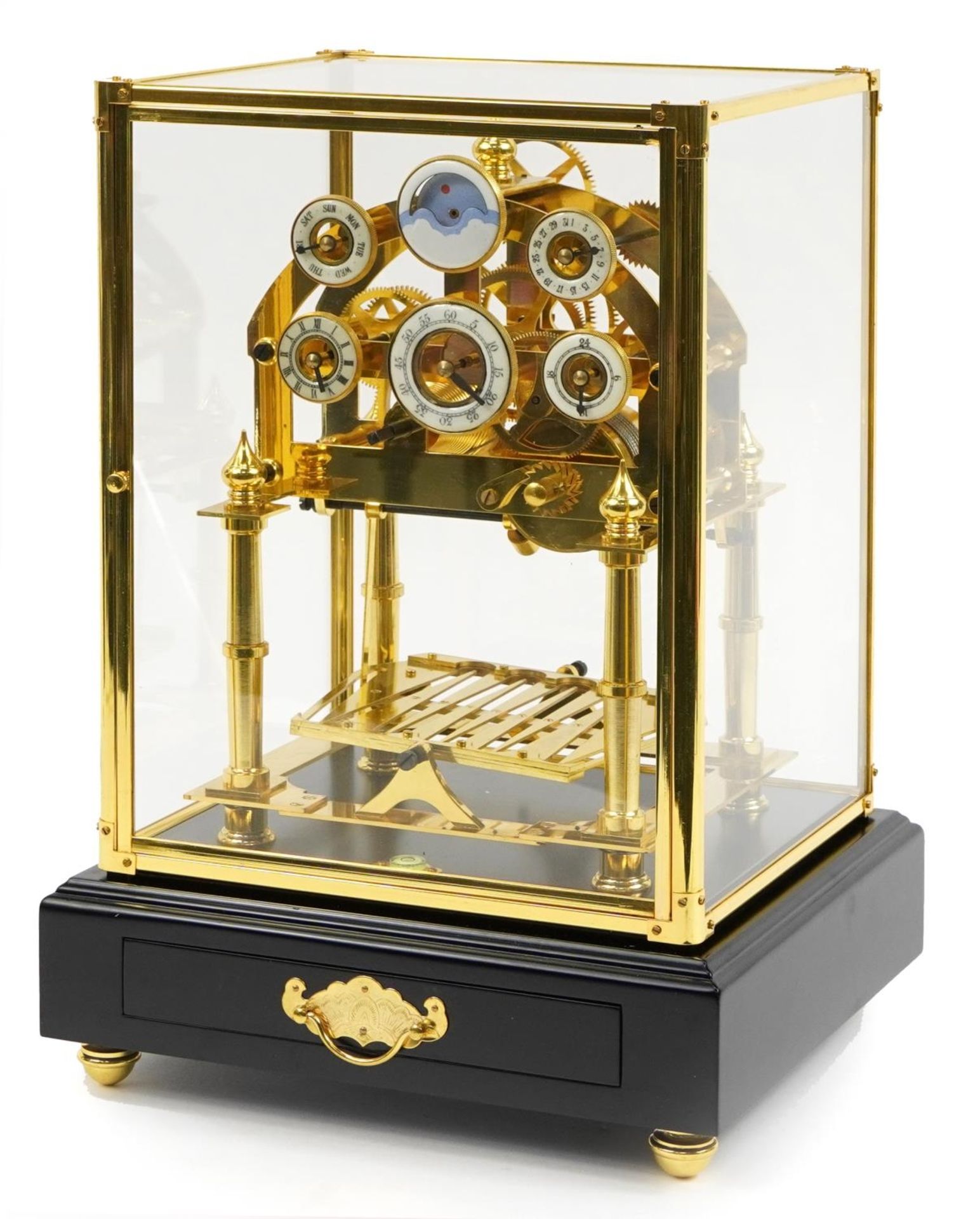 Congreve style rolling ball clock housed under a glazed brass display case with ebonised base,