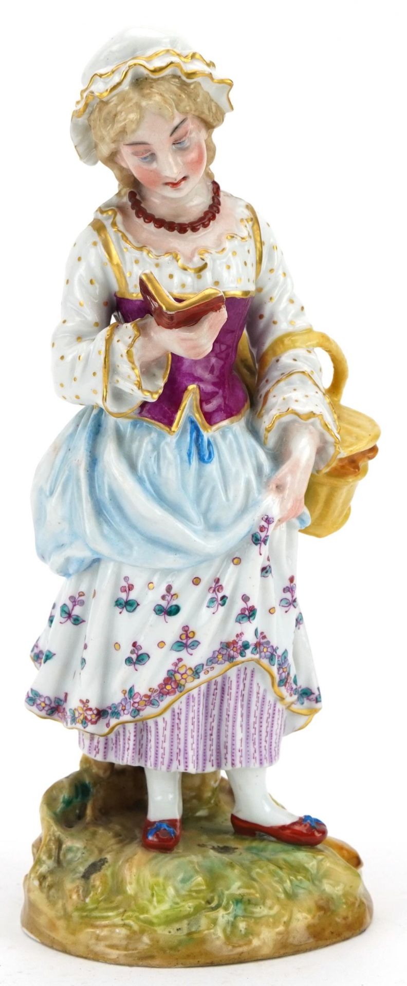 Continental hand painted porcelain figurine of a standing girl reading, 25.5cm high