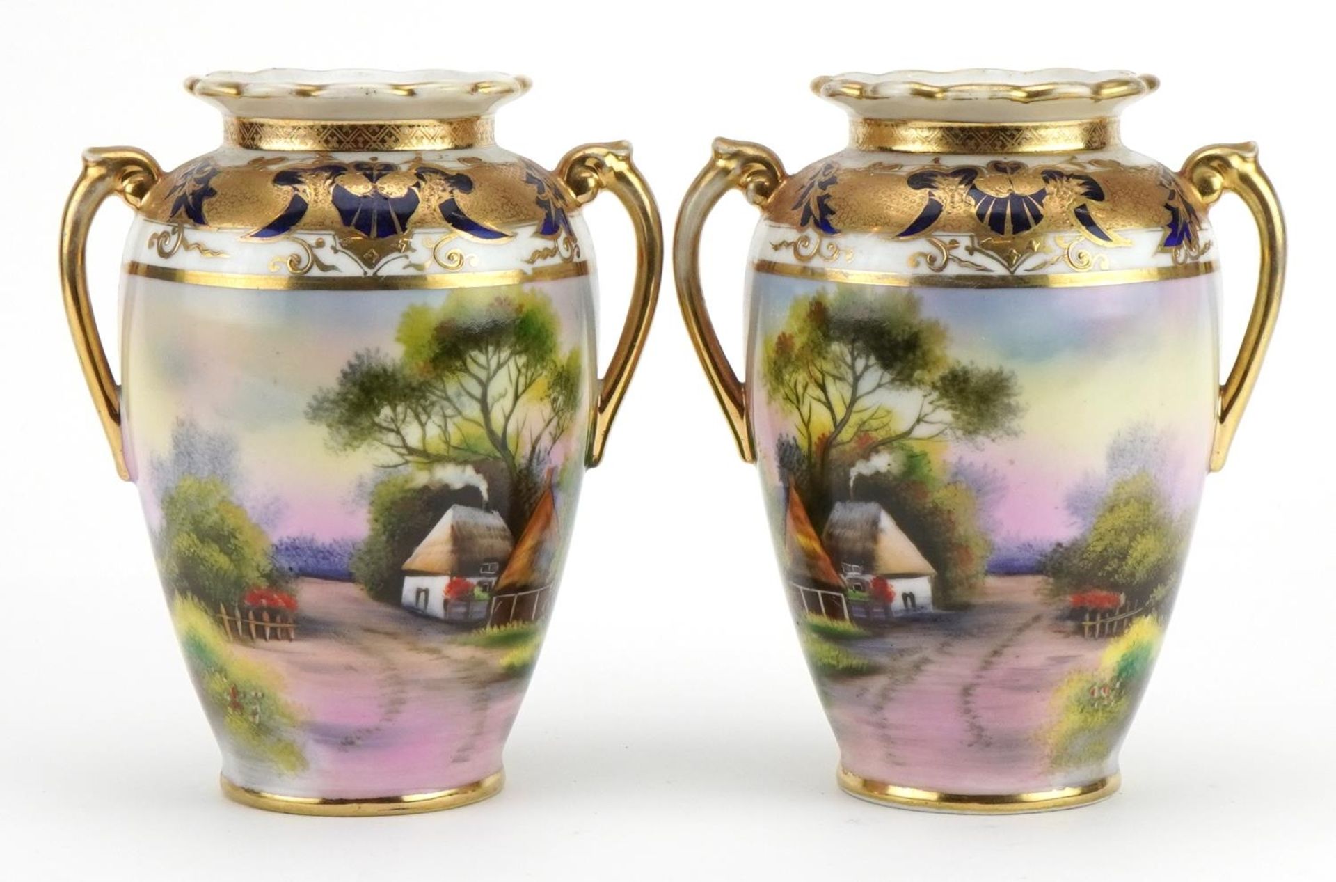 Pair of Noritake Japanese porcelain vases with twin handles, each hand painted with cottages