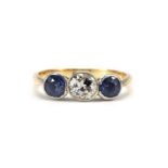 18ct gold diamond and sapphire three stone ring, the diamond approximately 4.3mm x 4.7mm, size M,