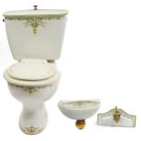 Victorian style bathroom set comprising toilet, cistern and wash basin with tap, the toilet and