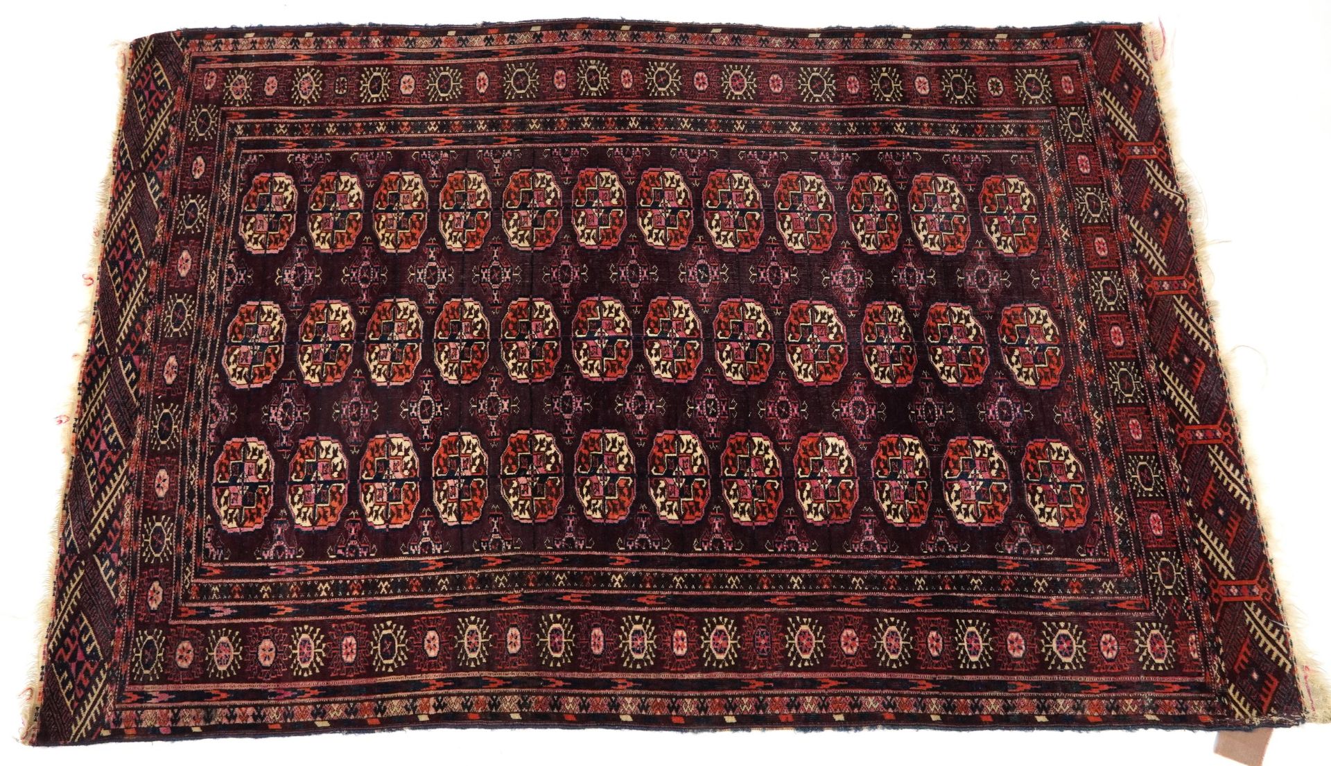 Rectangular Bokara red and blue ground rug with all over geometric design, 190cm x 126cm