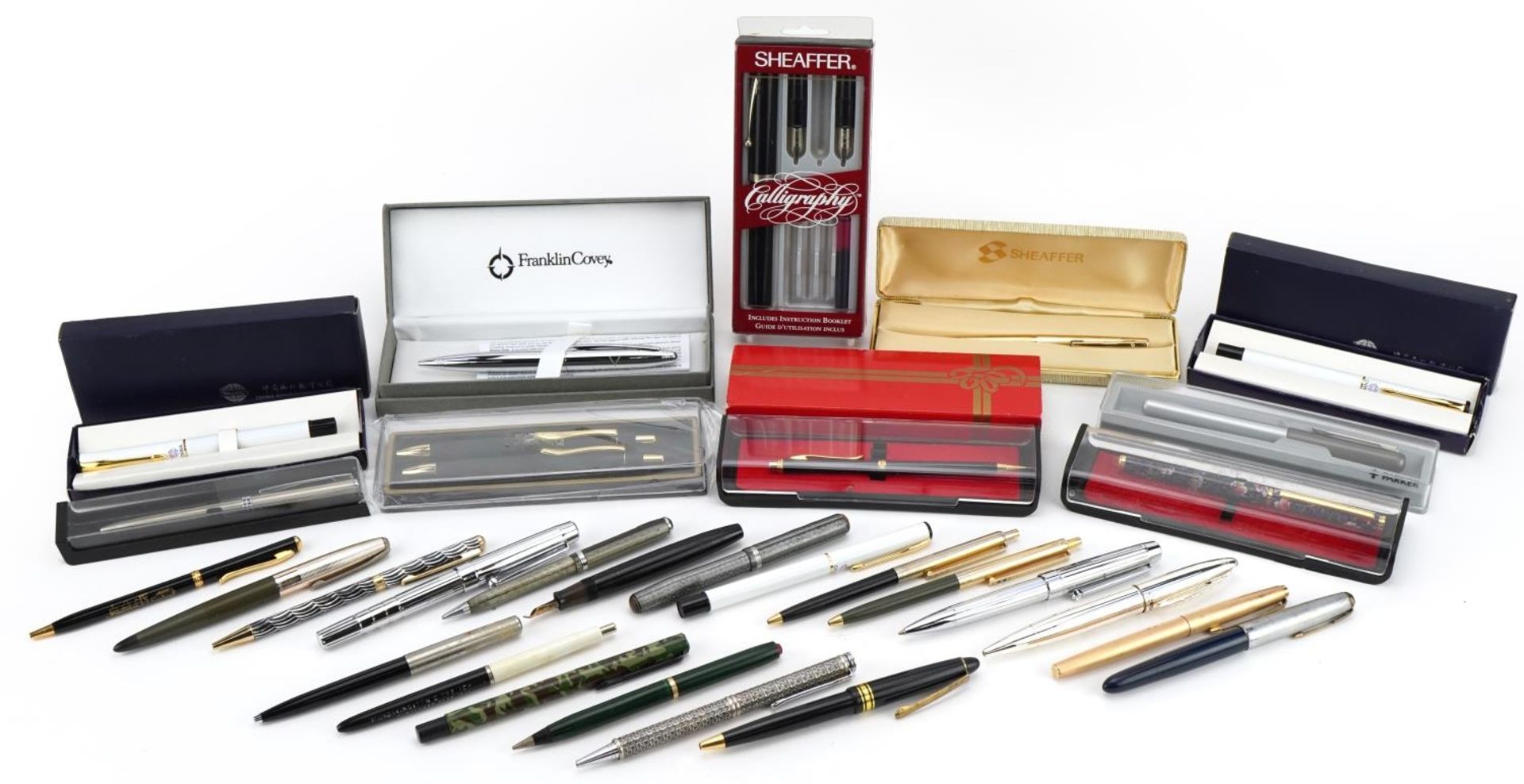 Vintage and later fountain pens and ballpoint pens including Parker and Sheaffer, one with 14ct gold