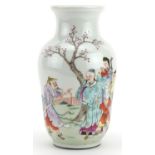 Chinese porcelain vase hand painted in the famille rose palette with figures before a landscape,