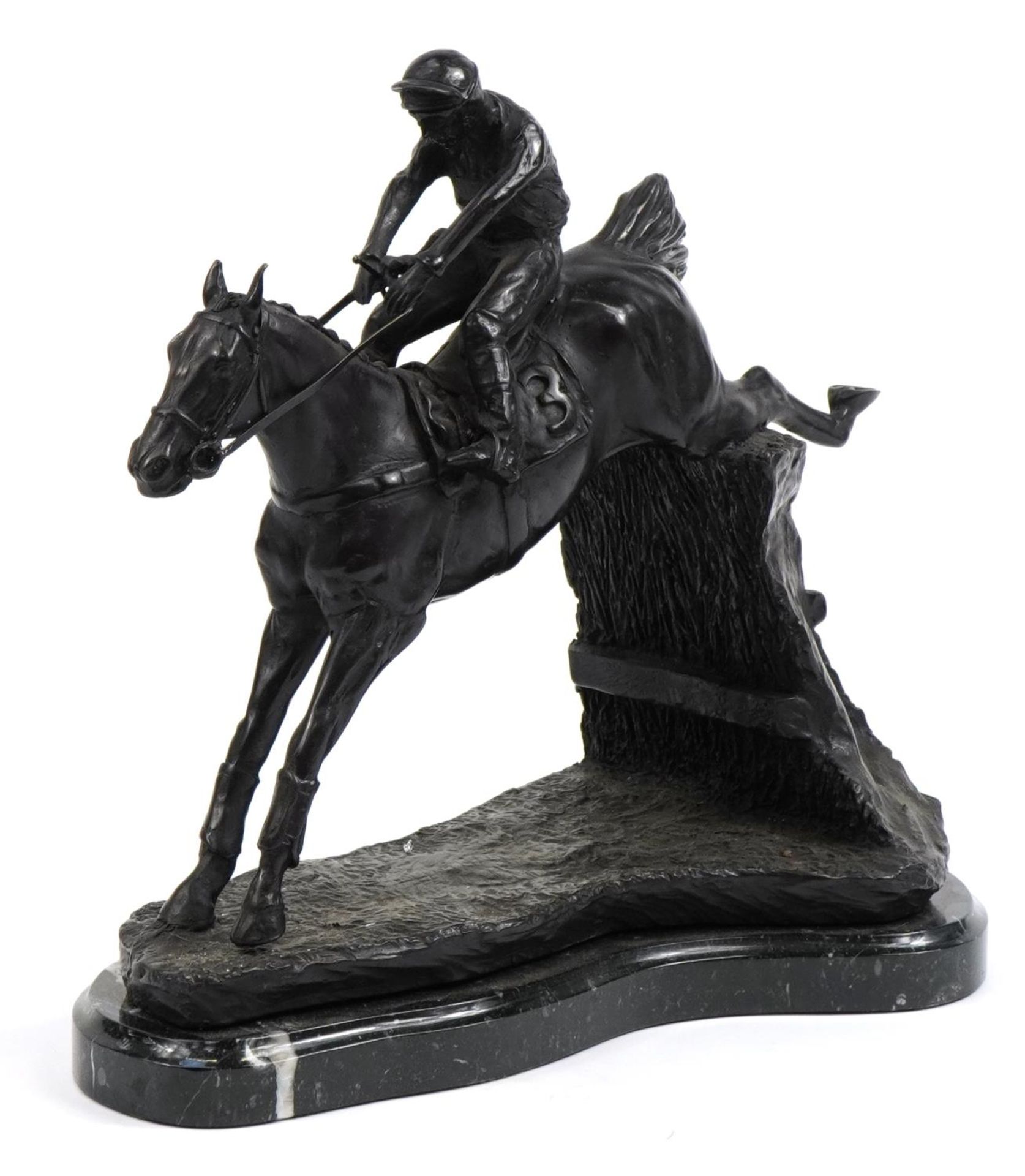 Large patinated bronze study of a jockey on horseback raised on a shaped marble base, 36cm in length