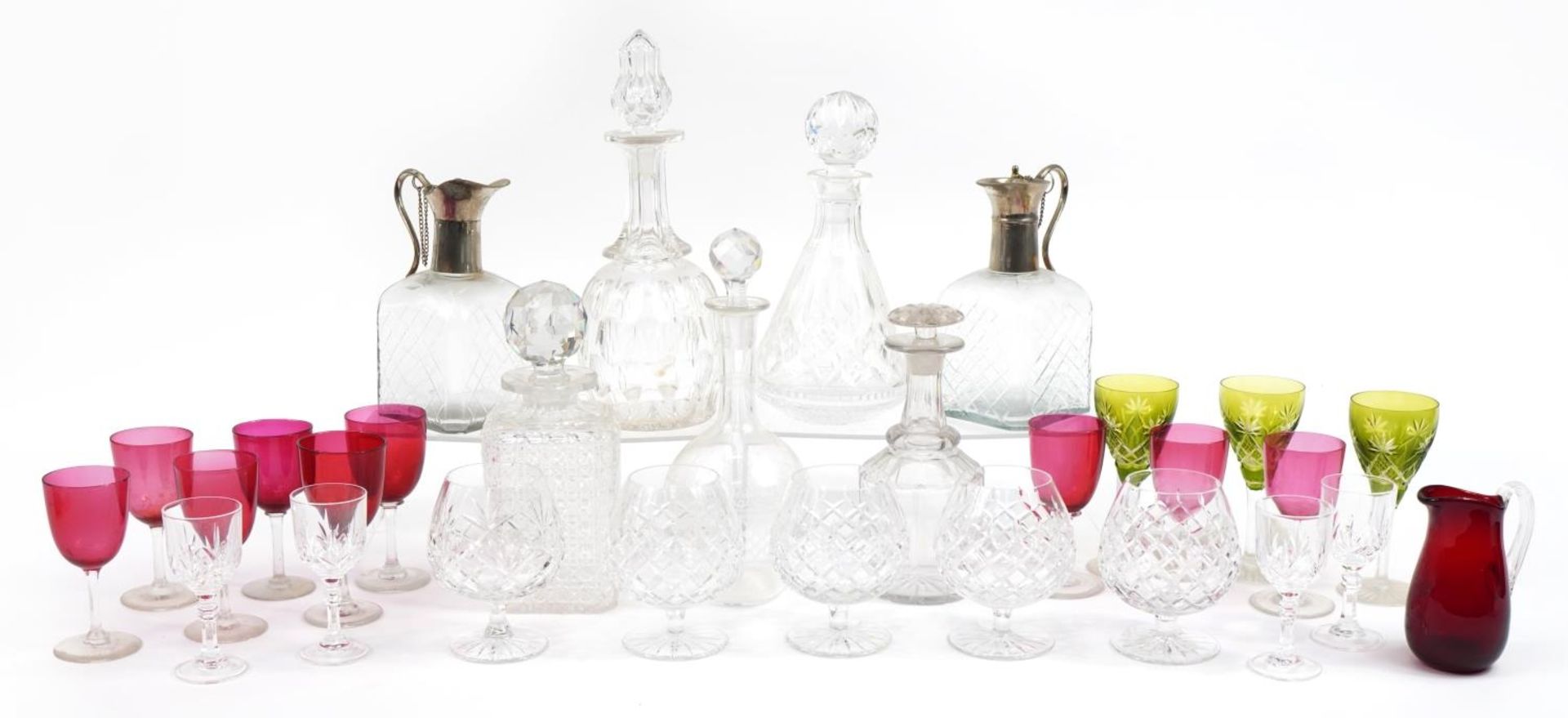 Antique and later cut glassware including brandy glasses, decanters and cranberry glass, the largest