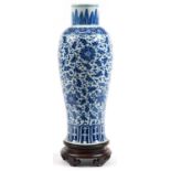Chinese blue and white porcelain vase hand painted with flowers, raised on carved hardwood stand,