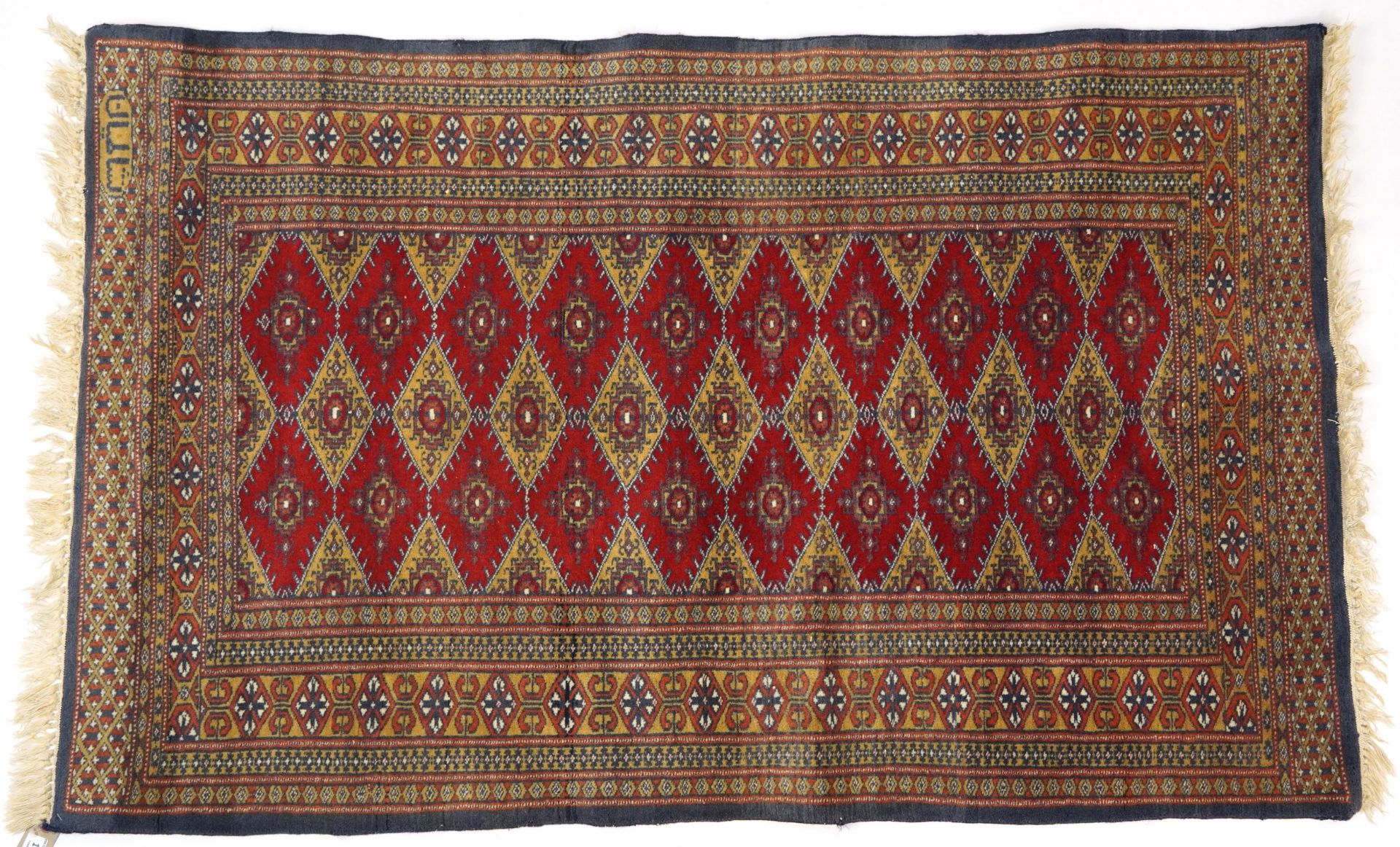 Rectangular red and blue ground rug with all over geometric design, 145cm x 91cm