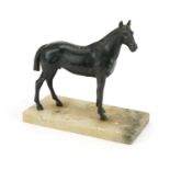 Painted spelter study of a horse raised on a rectangular onyx base, 20cm in length