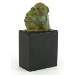 Donald Gilbert, verdigris bronze sculpture of two stylised baboons raised on a rectangular black