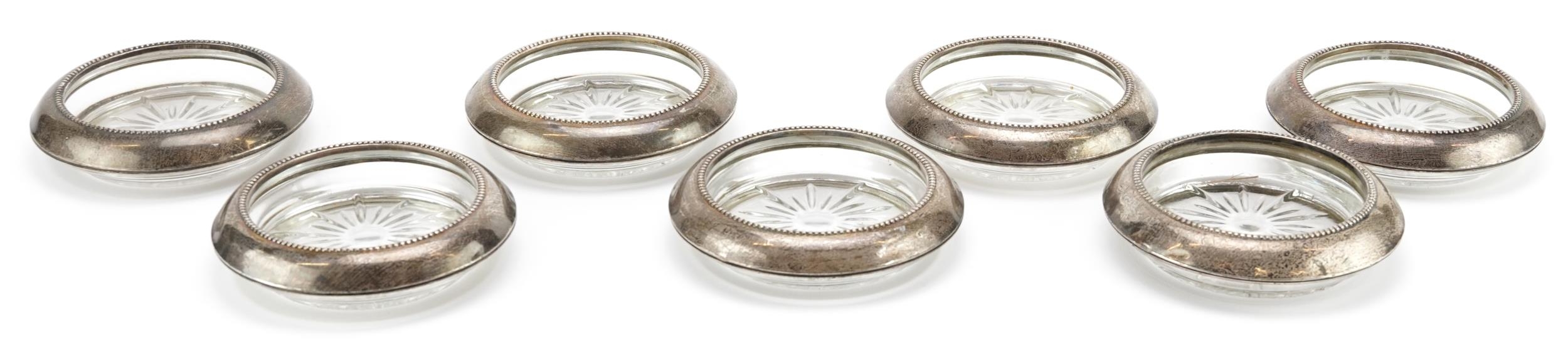 Frank M Whiting, set of seven circular sterling silver mounted dishes, 10cm in diameter