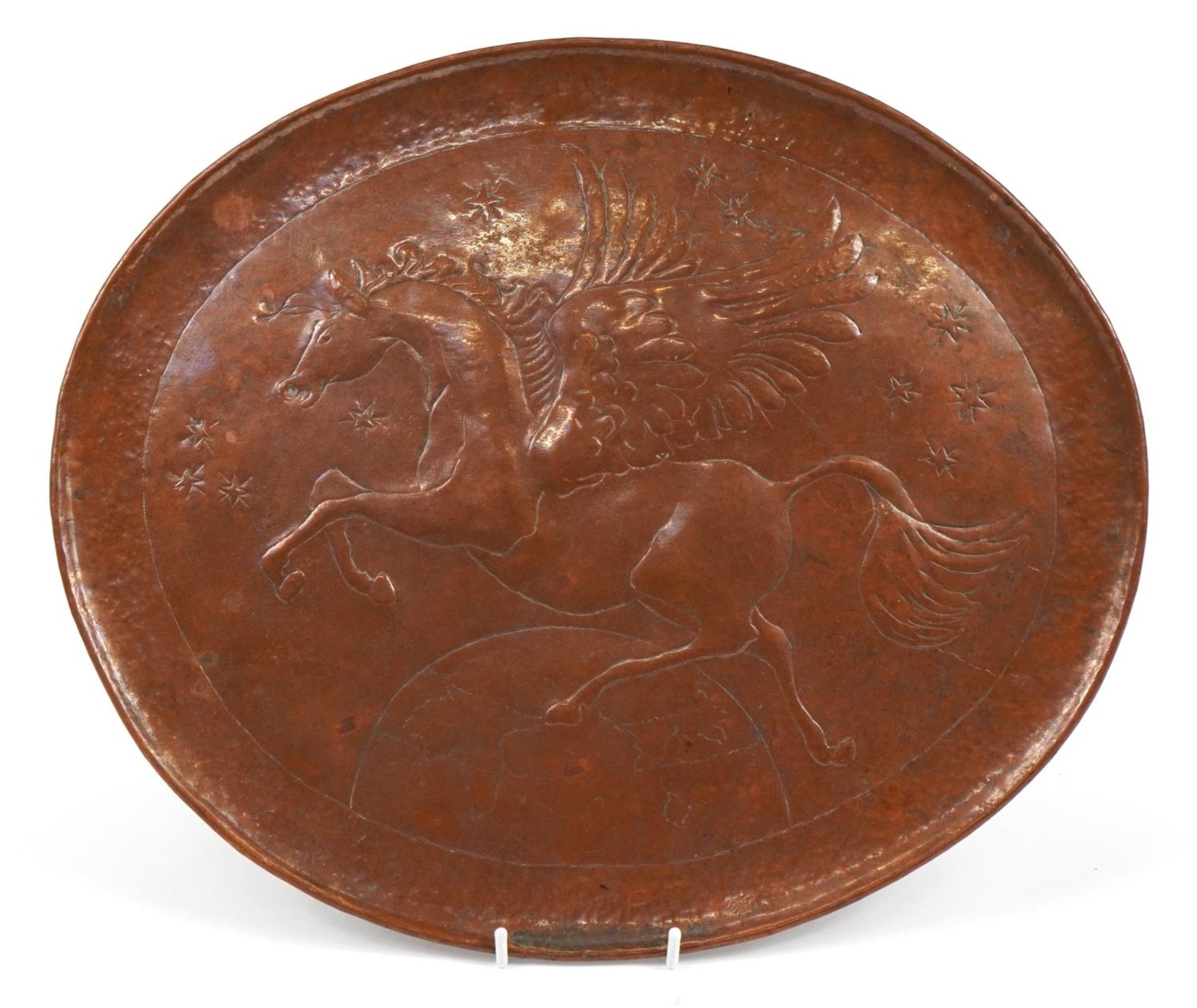 Manner of Newlyn, Arts & Crafts copper oval charger embossed with Pegasus, 43cm wide