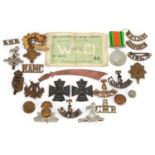 British militaria including shoulder titles, cap badges and World War II Defence medal
