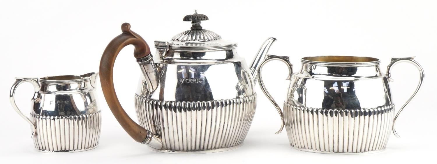 Lambert & Co, Victorian silver three piece tea service with demi fluted body, the teapot with wooden - Image 2 of 5