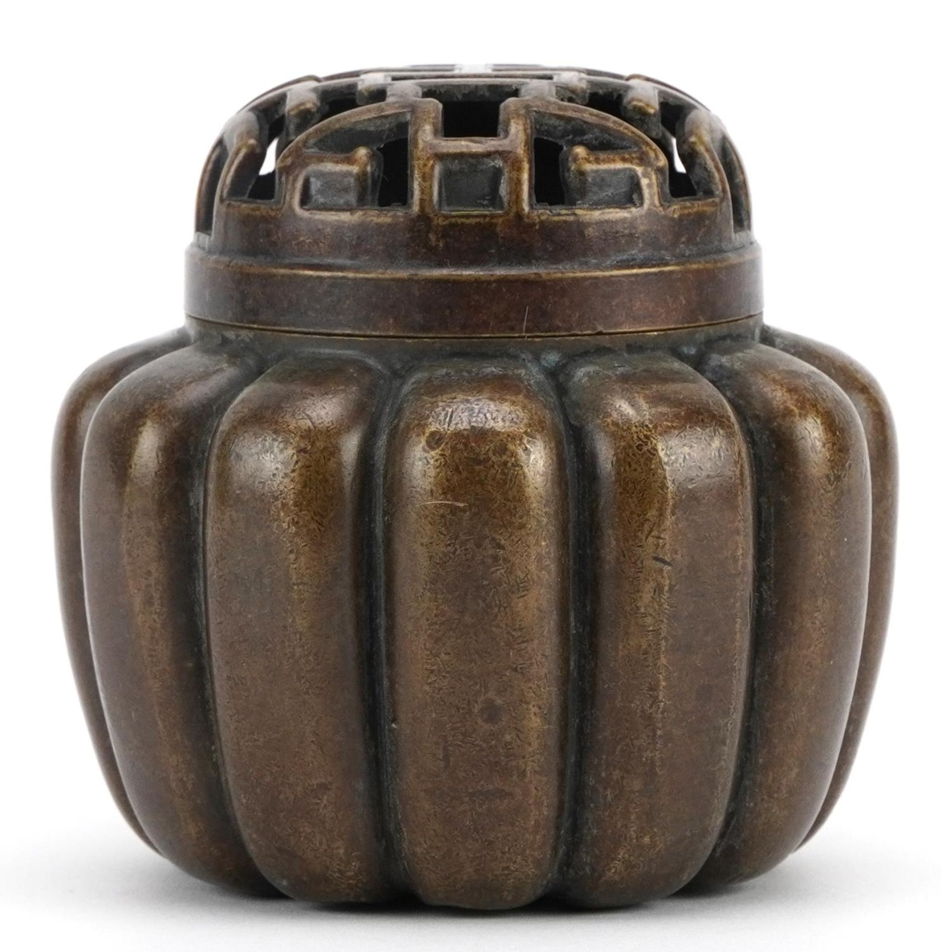 Chinese patinated bronze incense burner with pierced lid, character marks to the base, 10cm high