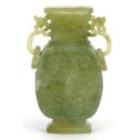 Chinese green hardstone vase with twin ring turned handles carved with archaic style faces, 11cm