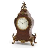 19th century French bird's eye maple cartouche shape mantle clock with ornate brass mounts having