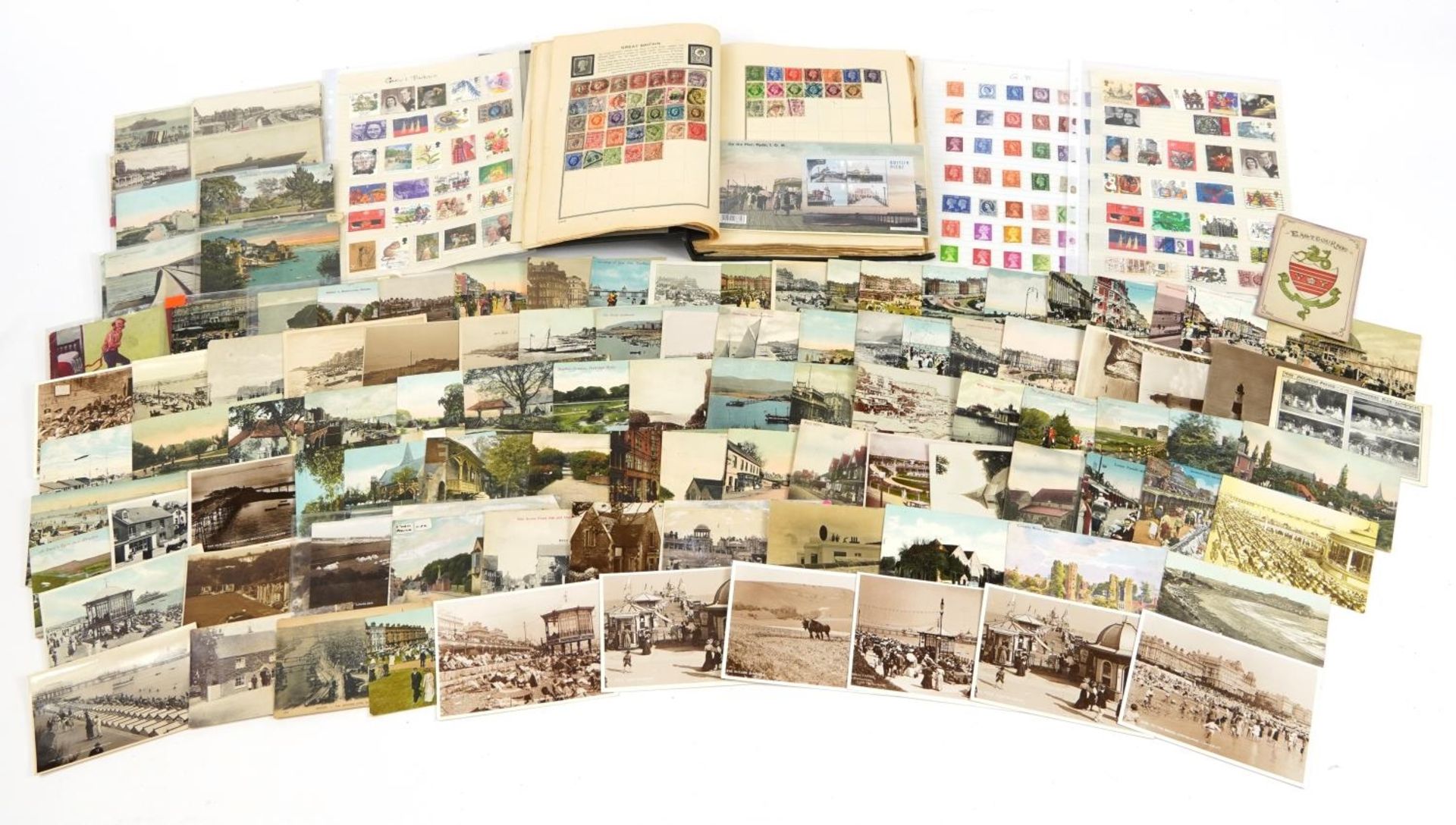 Antique and later ephemera including topographical postcards and stamps arranged in an album