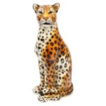 Large porcelain floor standing model of a seated leopard, 90cm high