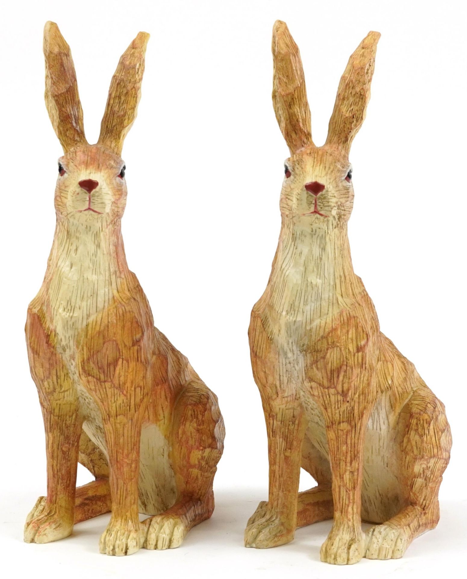Pair of painted carved wood seated hares, 34cm high