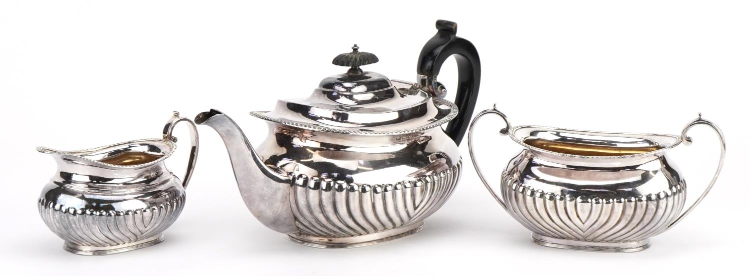 Victorian silver three piece tea service, the teapot with wooden handle and knop, G H maker's mark