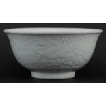 Large Chinese porcelain footed bowl having a blanc de chine glaze decorated in low relief with