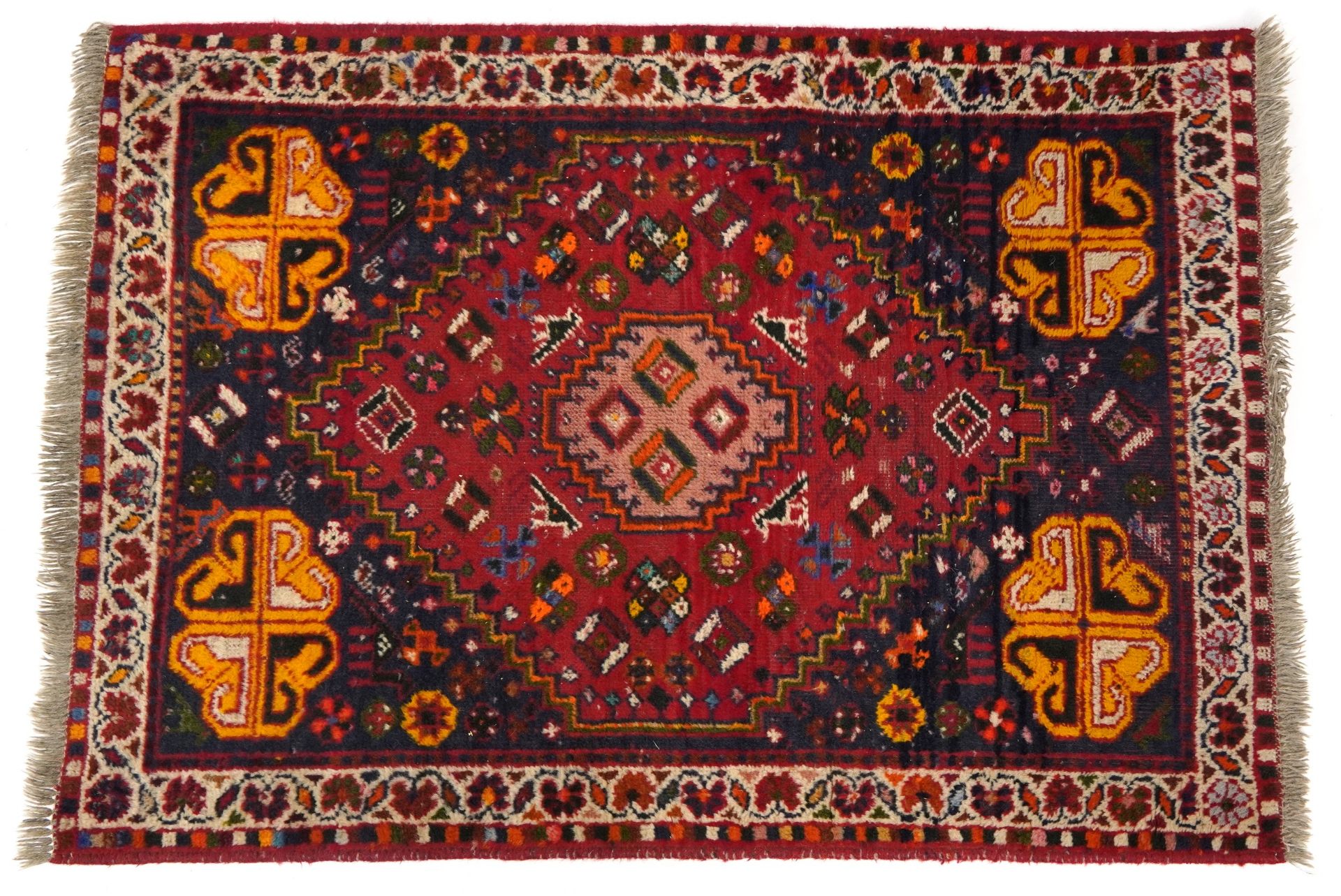 Rectangular red and blue ground rug having and allover geometric and animal design, 145cm x 102cm