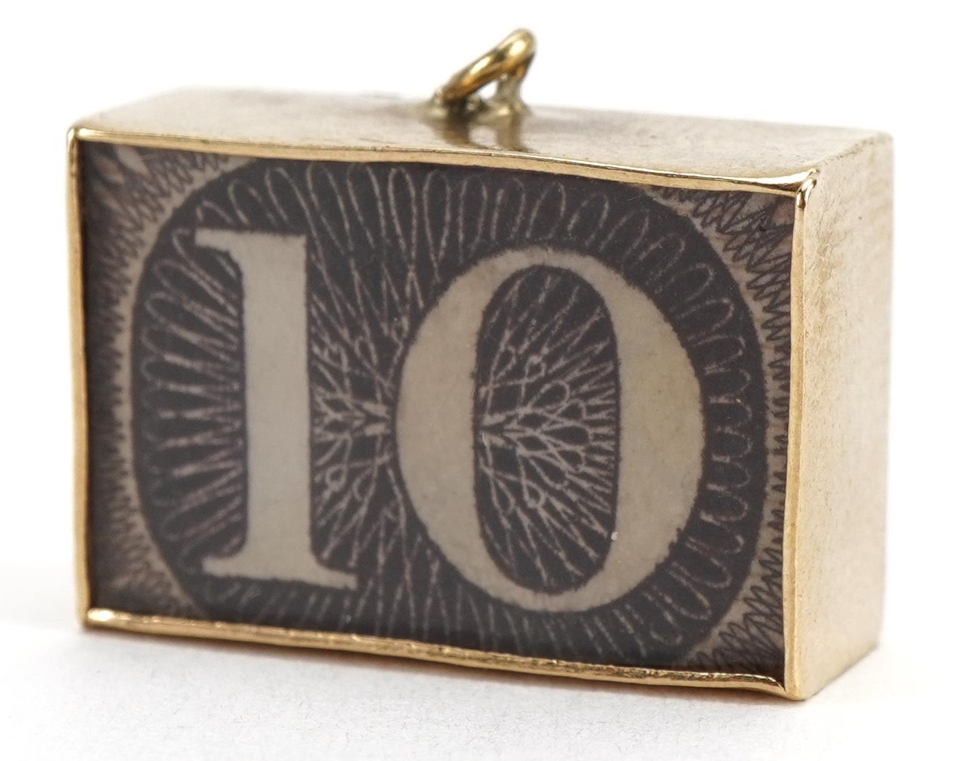 9ct gold emergency ten shilling note charm, 2.0cm wide, 3.5g