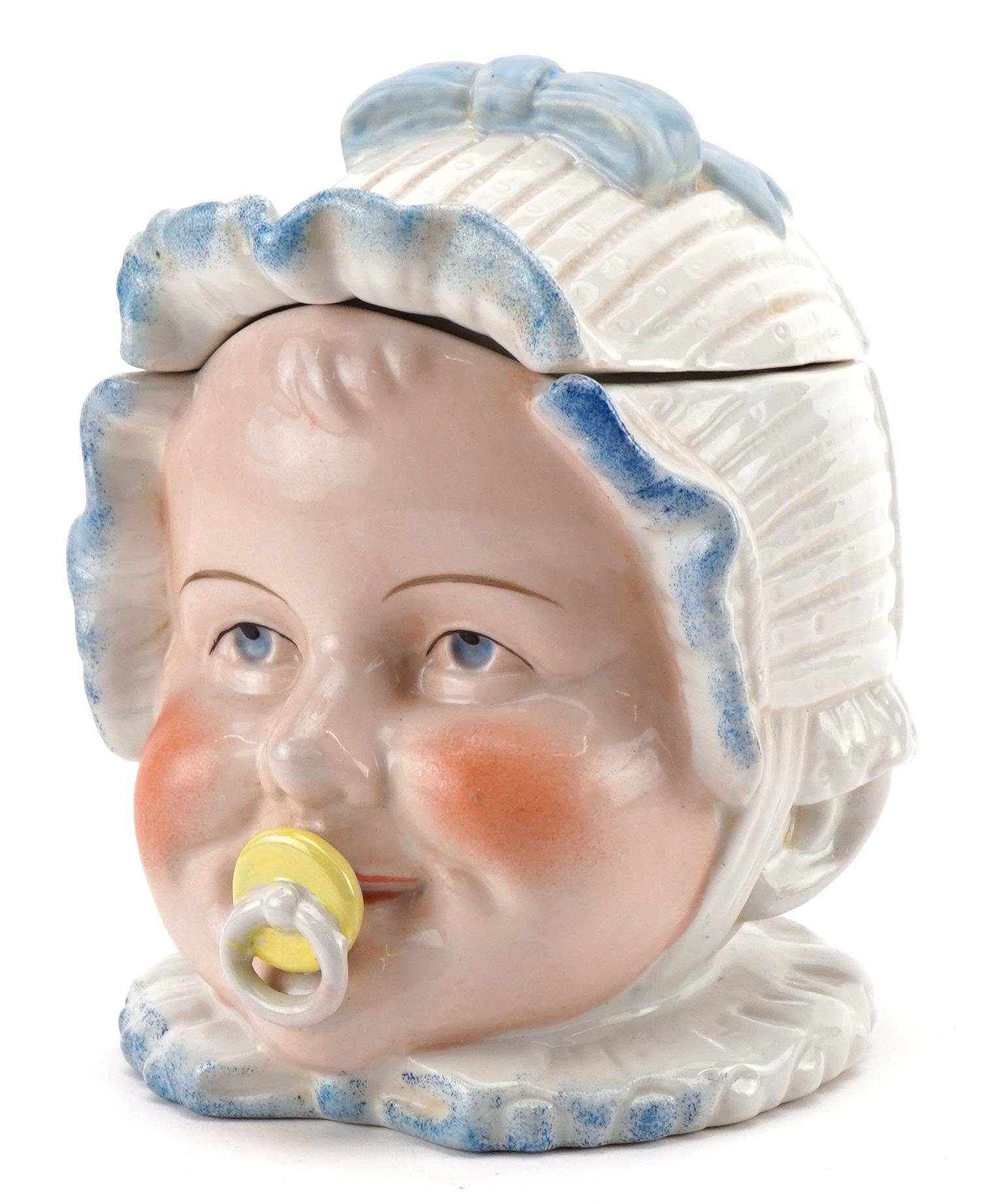 Continental porcelain baby's head tobacco box and cover, 13cm high