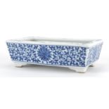 Chinese blue and white porcelain four footed planter hand painted with flower heads amongst