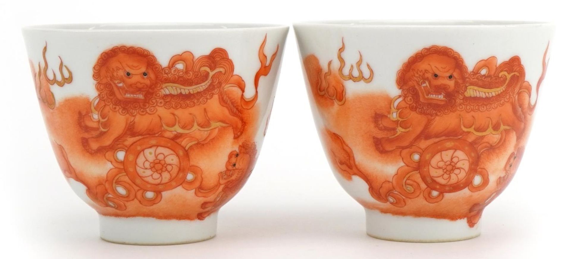 Pair of Chinese porcelain footed tea bowls hand painted in iron red with qilins, four figure
