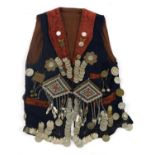 Persian coin set waistcoat with white metal talismans and coins, 59cm high
