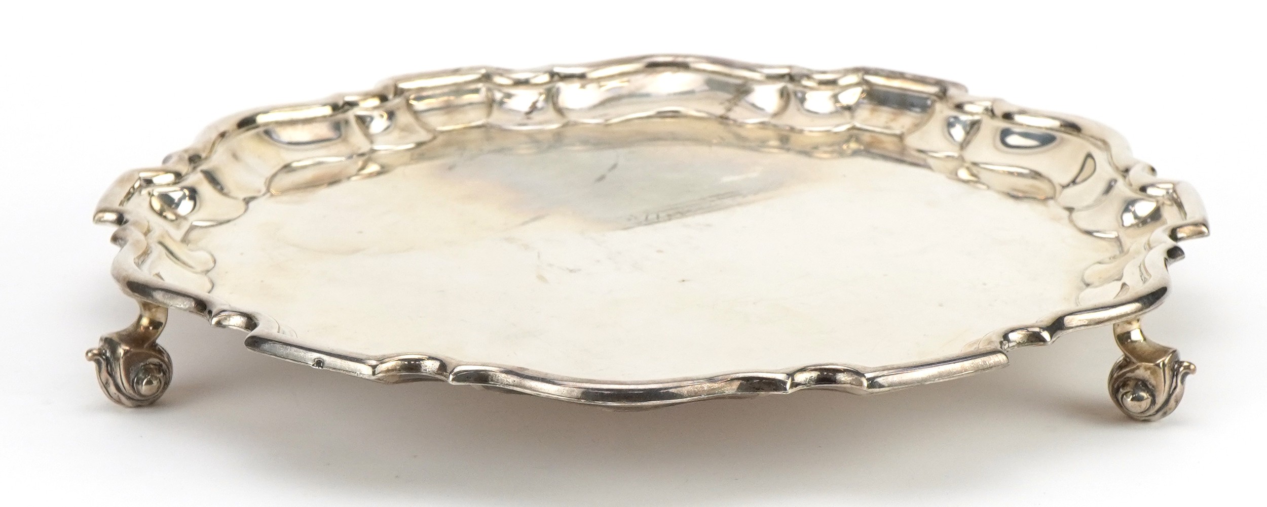 Martin Hall & Co Ltd, George V circular silver salver raised on three scrolled feet, Sheffield 1922,