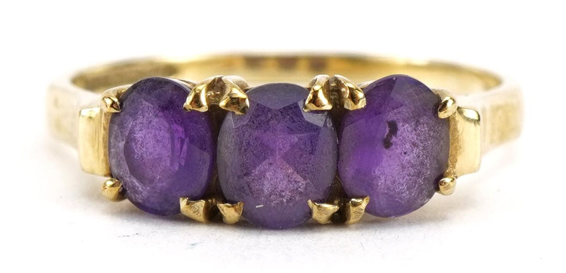 9ct gold amethyst three stone ring, the largest amethyst approximately 5.2mm x 3.8mm, size L, 1.8g