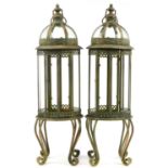 Pair of partially gilt and glazed lantern design candleholders, 82cm high