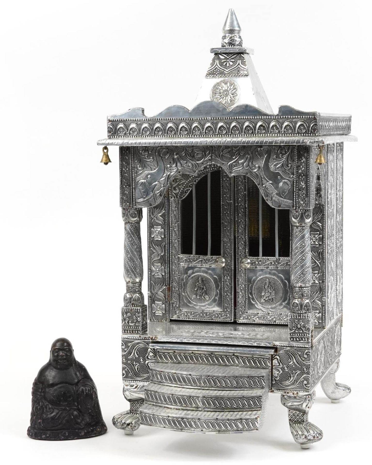 Large silvered table top Indian shrine housing a stoneware figure of Buddha, 71cm high