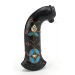 Islamic hardstone dagger handle carved with a mythical cat inset with red cabochons, 13cm in length