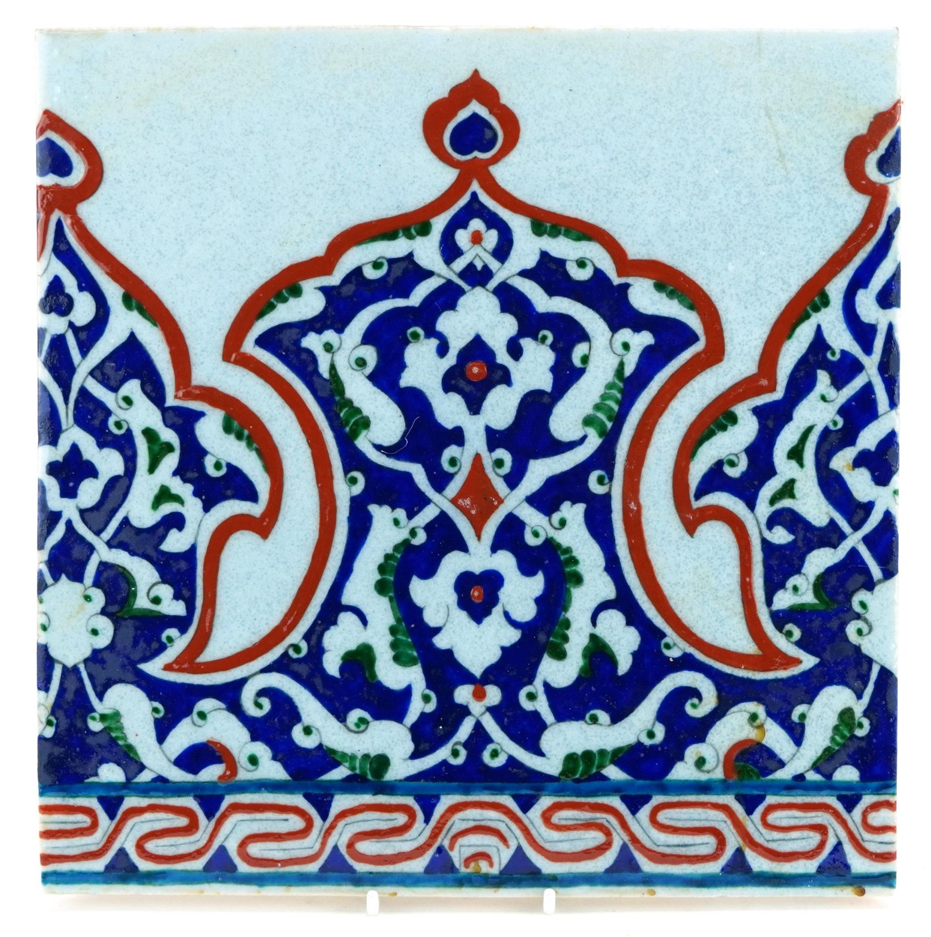 Turkish Ottoman Iznik pottery tile hand painted with stylised flowers, 27.5cm x 27.5cm